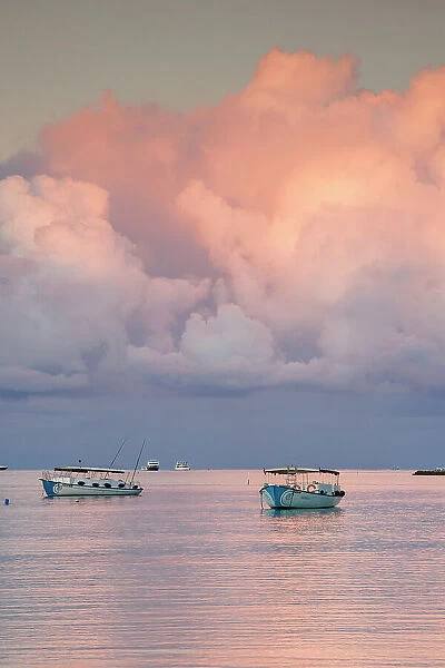 Boats at sunset on a tropical island, North Ari Atoll, the Maldives