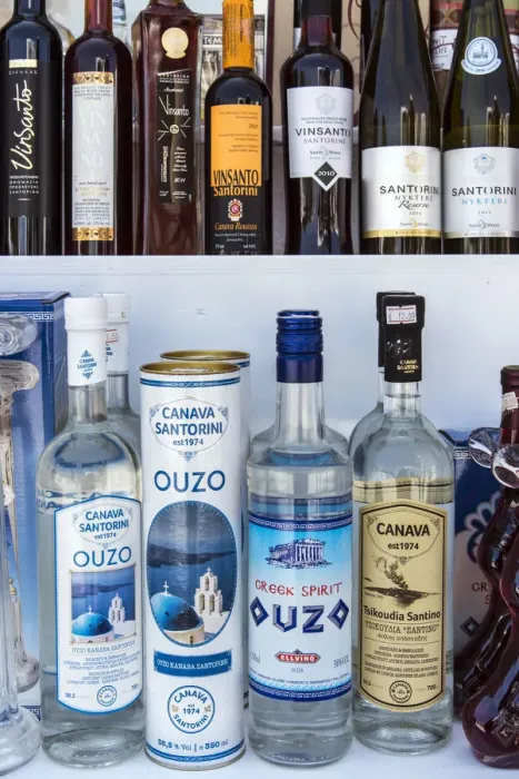 Framed Print : Bottles of traditional Ouzo liquor and local Greek wines on sale in a shop of Oia