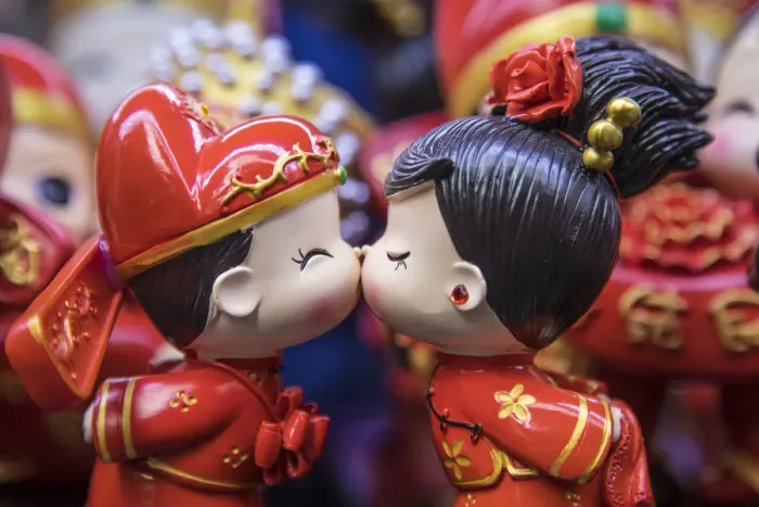 Framed Print : Boy and girl ornaments kissing, Old City market, Shanghai, China