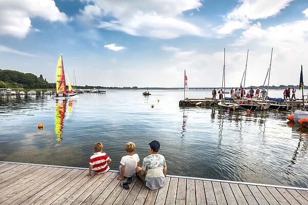 Boys watching a catamaran, Altefaahr, RAogen Island, Mecklenburg-Western Pomerania