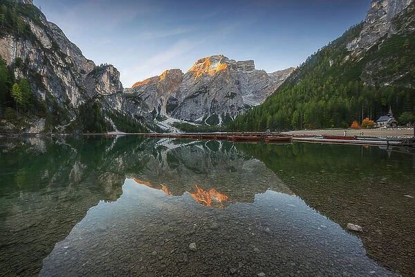 The Braies lake taking the first light of the day on a windy summer morning. Dolomites, Italy