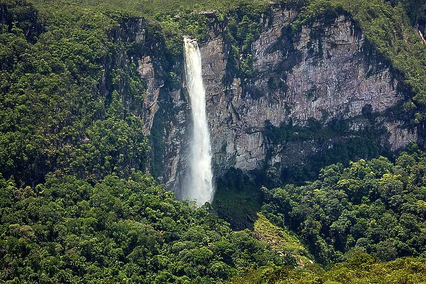 Brazil, Amazonas, Amazon, Rio Negro, Serra do Araca State Park, Araca tepui, waterfall plunging from the top of the tepui surrounded by rainforest