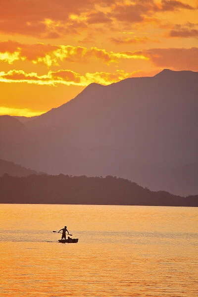 Brazil, Rio de Janeiro State, Angra dos Reis, Ilha Grande, a fisherman silhouetted