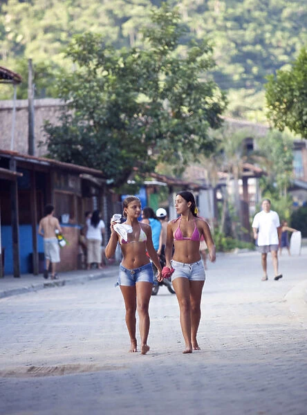 Brazil, Rio de Janeiro State, Costa Verde (Green coast), Paraty, two sufer girls walking