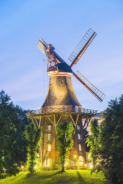 Bremen, Bremen State, Germany. The MAohle am Wall windmill illuminated at dusk