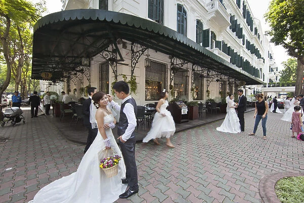 Brides and Grooms being photographed infront of the Sofitel Metropole Legend Hotel
