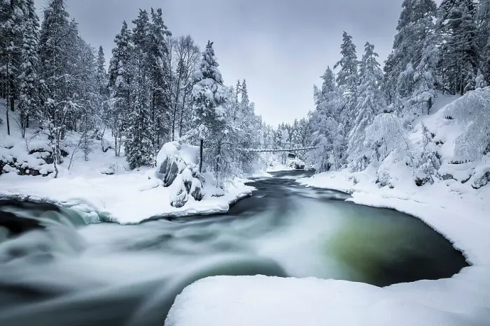 Framed Print : Bridge over river in snow-covered forest, Oulanka National Park, Finland Framed Print : Bridge over river in snow-covered forest, Oulanka National Park, Finland