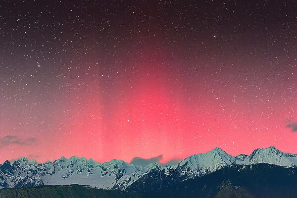 Bright colorful sky with Aurora Borealis over snowcapped mountains, Val Masino, Valtellina, Sondrio province, Lombardy, Italy