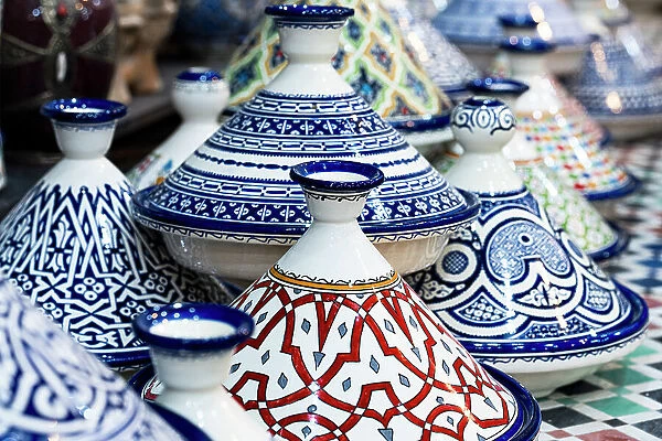 Brightly colored tagine bowls and plates in a ceramic shop in Fes, Morocco