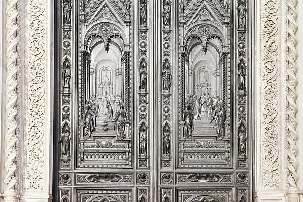 Bronze front door of tf Saint Mary of the Flower Cathedral, Florence, Tuscany, Italy