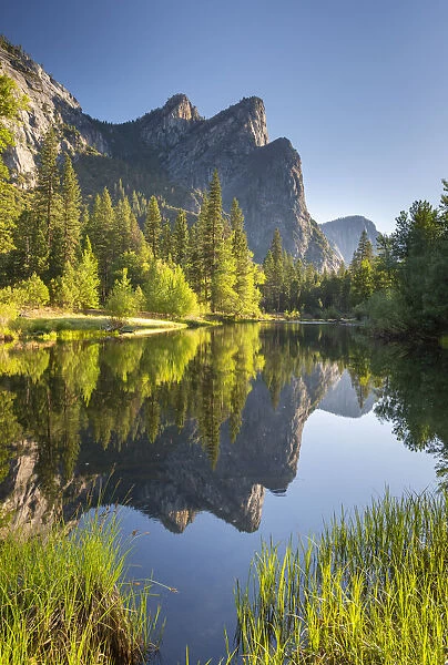 The Three Brothers mountains reflected in the River Merced in Yosemite Valley, Yosemite National Park, California, USA