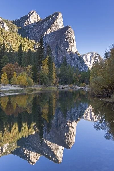 The Three Brothers reflected in the Merced River at dawn, Yosemite Valley, California, USA