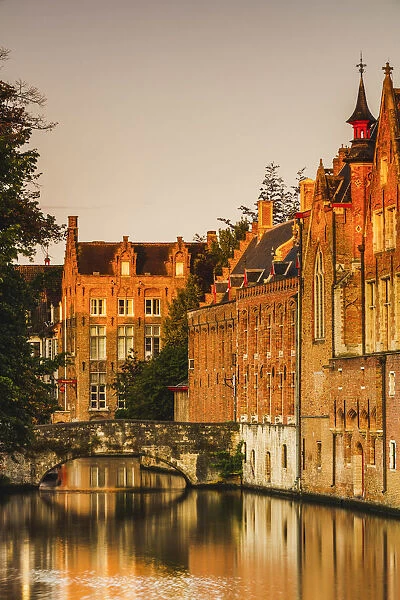 Bruges old city reflecting in the water canal at sunrise, Belgium