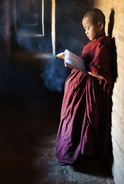 A buddhist monk praying in the temple, Bagan, Burma  /  Myanmar