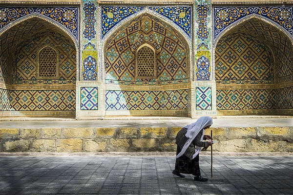 Bukhara, Uzbekistan, Central Asia. Old woman close to Nadir Divan-Beghi madrasah