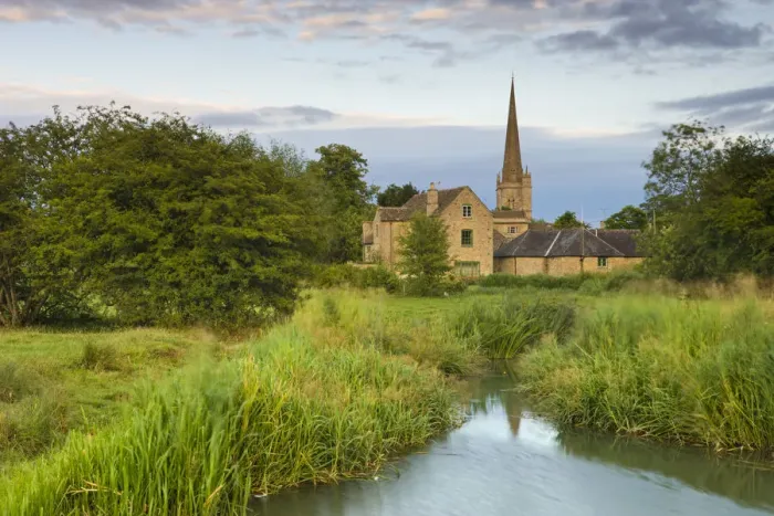 Framed Print : Burford Mill and Church viewed from the River Windrush in the water meadows, Burford