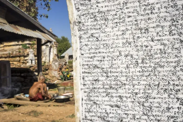 Framed Print : Burmese script on wall with senior Buddhist monk in background, Hsipaw, Hsipaw Township