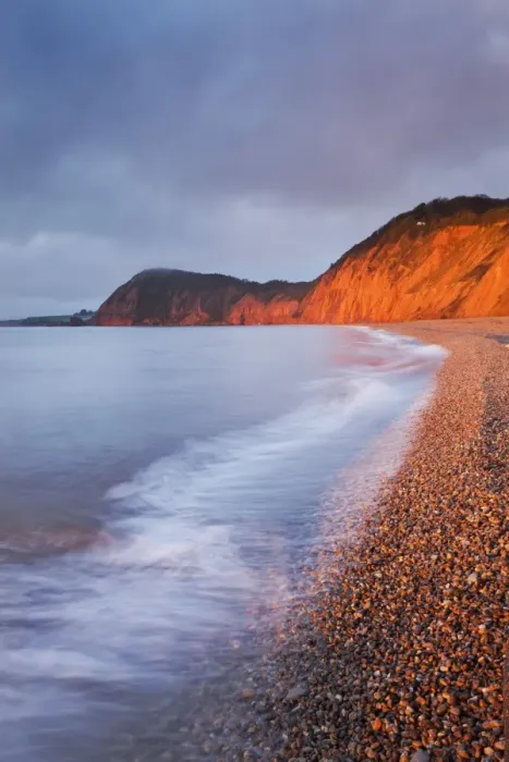 Framed Print : Burning red cliffs at Sidmouth on the Jurassic Coast, Devon, England. Winter Framed Print : Burning red cliffs at Sidmouth on the Jurassic Coast, Devon, England. Winter