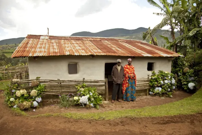 Framed Print : Burundi. A couple outside a traditional house on their farm Framed Print : Burundi. A couple outside a traditional house on their farm