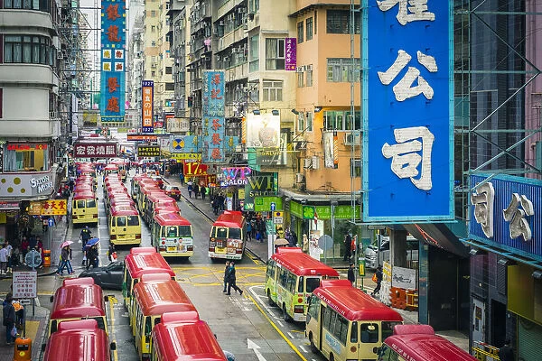 Busses lined on Tung Choi Street in Mong Kok at rush hour, Kowloon, Hong Kong, China