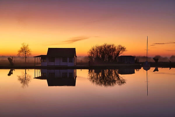 Cabin Reflecting in River Thurne at Sunset, Norfolk Broads National Park, Norfolk