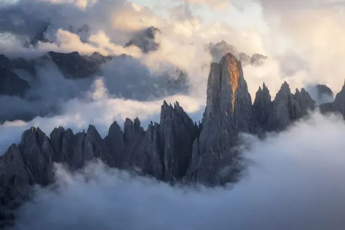 Framed Print : The Cadini di Misurina emerging from the sea of clouds during a stormy late summer sunset. Dolomites, Italy Framed Print : The Cadini di Misurina emerging from the sea of clouds during a stormy late summer sunset. Dolomites, Italy