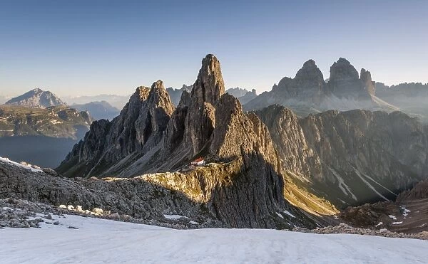 The Cadini di Misurina peaks are shot as the sun is rising in the Dolomites, with
