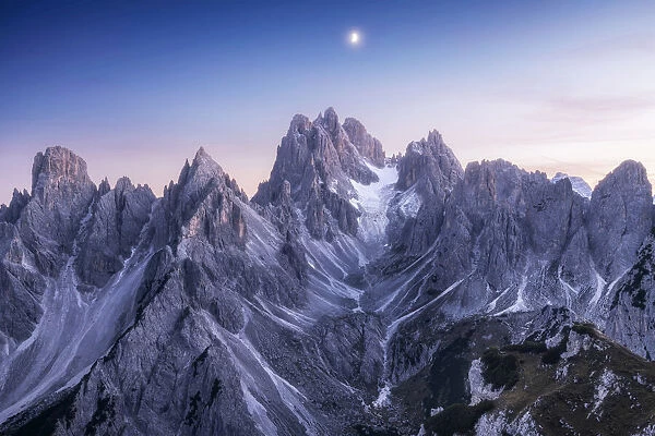 The Cadini di Misurina taking the last light of the day with the rising moon above them. Dolomites, Italy