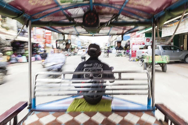 Cambodia, Battambang, view from inside a remorque motorbike taxi, motion blur