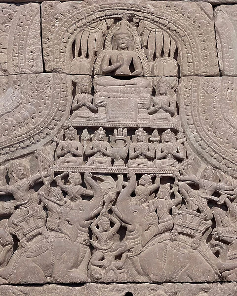 Cambodia, detail of a Khmer carving from Angkor Wat showing a seated buddha in the Vitarka Mudra (hand gesture of teaching the dharma, or Buddhist law). Elephants and warriors below