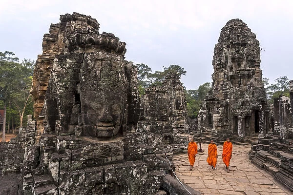 Cambodia, Siem Reap, Angkor Wat complex. Monks inside Bayon temple, at sunrise (MR)