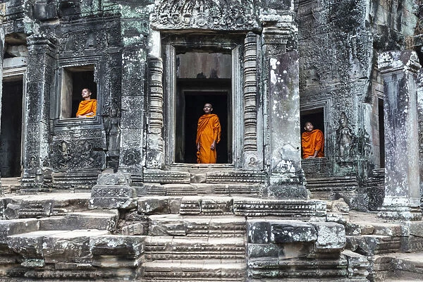 Cambodia, Siem Reap, Angkor Wat complex. Monks inside Bayon temple (MR)