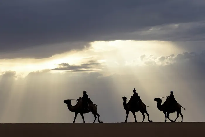 Framed Print : Three camel herders riding their camels in the Khongor Dunes at sunset, Gobi Desert, Mongolia, Asia