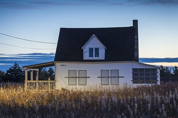 Canada, New Brunswick, Acadian Peninsula, Miscou Island, old house, dusk