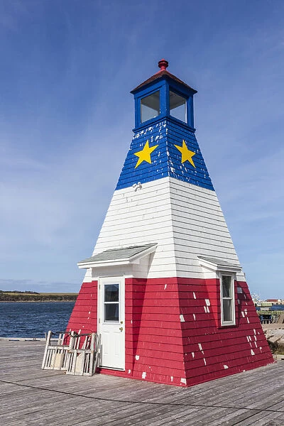 Canada, Nova Scotia, Cabot Trail, Cheticamp, town lighthouse painted in Acadian colors
