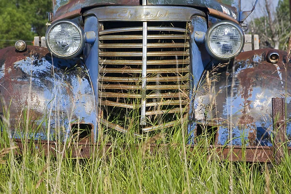 Canada. An old car in a farmers field on the Canadian Prairie