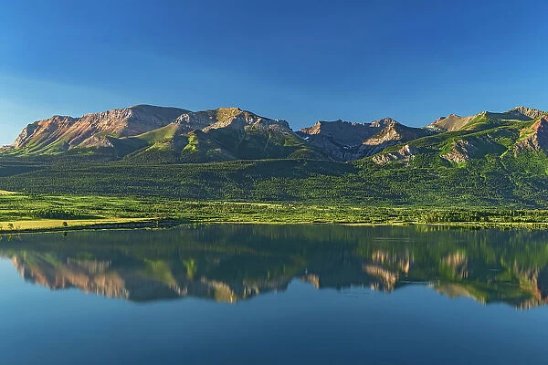 Canadian Rocky Mountains and Sofa Mountain reflected in Lower Waterton Lake Waterton Lakes National Park, Alberta, Canada