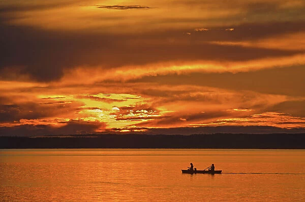 Canoeing on Clear Lake at sunset, Riding Mountain National Park, Manitoba, Canada