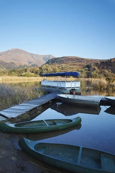 Canoes on lake with Drakensberg mountains in background, Ukhahlamba-Drakensberg Park