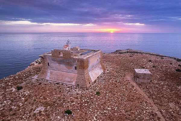 Capo Passero island at sunrise with the light house and the castle, Porto Palo di Capo Passero, Siracuse province, Sicily, Italy