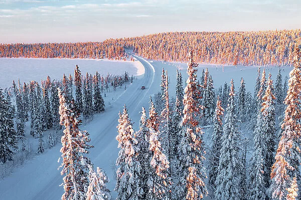 car driving on an icy road in the snowy forest, Kangos, Norrbotten County, Lapland, Sweden