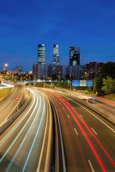 Framed Print : Car light trails on urban highway with Four Towers Business district in Paseo de la Castellana at twilight, Madrid, Spain Framed Print : Car light trails on urban highway with Four Towers Business district in Paseo de la Castellana at twilight, Madrid, Spain