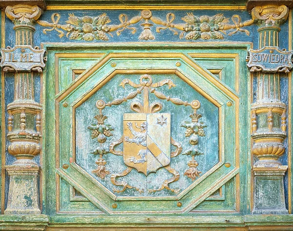 Carved painted coat of arms of Katherine Briazonnet on wooden front door of Chateau