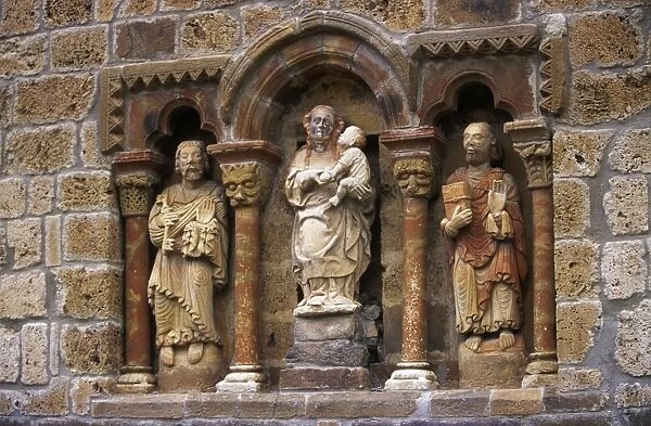 Detail of carved stone figures on the XIIth C Romanesque