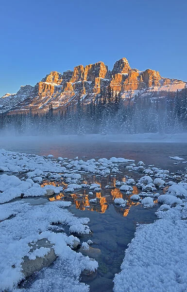 Castle Mountain reflected in the Bow River. at sunrise. Castle Junction, Banff National Park, Alberta, Canada