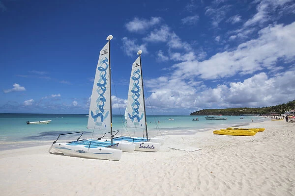 Catamarans on the beach ready to sail in the blue Caribbean Sea Dickenson Bay Antigua
