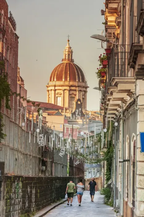 Framed Print : Catania, Sicily. A couple walking with the Cathedral in the background Framed Print : Catania, Sicily. A couple walking with the Cathedral in the background