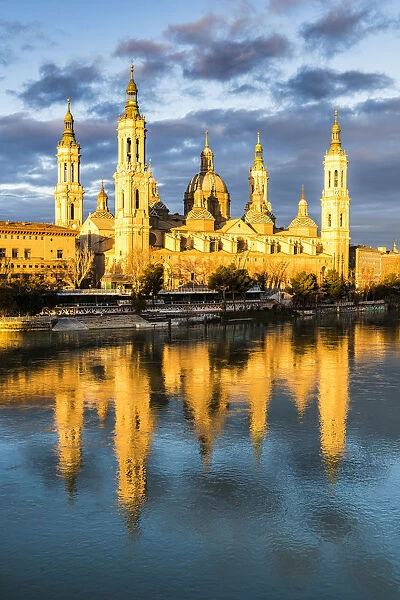 Cathedral of Our Lady of the Pillar reflected in Ebro river at sunrise. Zaragoza