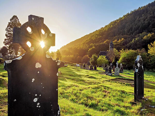 Celtic cross and St. Kevin's Church at sunrise, Early Medieval Monastic Settlement, Glendalough, County Wicklow, Ireland