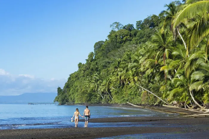 Framed Print : Central America, Costa Rica, Golfito, a young couple on a black sand beach in Piedras Framed Print : Central America, Costa Rica, Golfito, a young couple on a black sand beach in Piedras